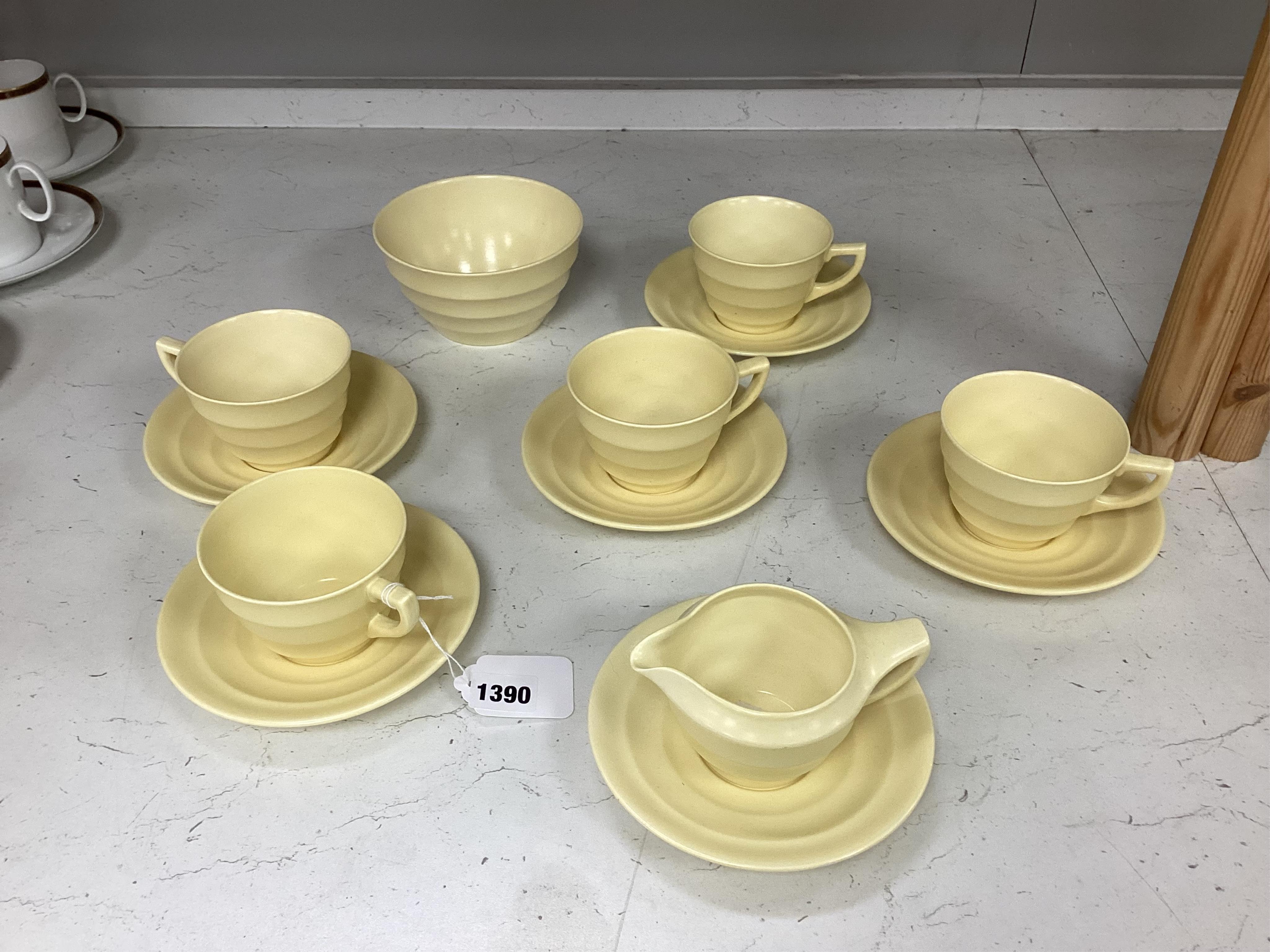 A part-set of Keith Murray Wedgwood teaware in matt straw, five cups and saucers, milk jug, sugar bowl and a spare saucer